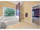 Bright bathroom featuring a soaking tub with jets and a glass-enclosed shower at 9135 Woodhaven Way, Mcdonough, GA 30253