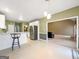 Dining room with eat in bar, view to living room, stainless appliances and natural light at 9135 Woodhaven Way, Mcdonough, GA 30253