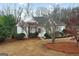 Traditional home featuring a stone facade and manicured landscaping offering an inviting curb appeal at 9135 Woodhaven Way, Mcdonough, GA 30253