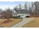Exterior view of home, featuring a two-car garage, long driveway, and well-manicured lawn at 9135 Woodhaven Way, Mcdonough, GA 30253