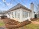 Back exterior view of home with stucco, windows, patio door, and lawn with pine straw at 9135 Woodhaven Way, Mcdonough, GA 30253