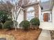 Home's front exterior featuring a stone facade, arched window, and inviting front door at 9135 Woodhaven Way, Mcdonough, GA 30253