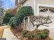 Exterior view featuring an attached garage with a well-maintained yard and landscaping at 9135 Woodhaven Way, Mcdonough, GA 30253