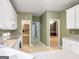 Bright kitchen with white cabinets, white appliances, and view to the dining and living room at 9135 Woodhaven Way, Mcdonough, GA 30253