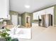 Charming kitchen featuring white cabinets, neutral countertops and modern appliances at 9135 Woodhaven Way, Mcdonough, GA 30253