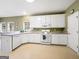 Charming kitchen featuring white cabinets, neutral countertops and modern appliances at 9135 Woodhaven Way, Mcdonough, GA 30253