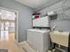 Convenient laundry area with appliances, storage, and adjacent utility sink at 9135 Woodhaven Way, Mcdonough, GA 30253