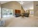 Spacious living room with vaulted ceilings, neutral carpet, two sofas and view to another room at 9135 Woodhaven Way, Mcdonough, GA 30253