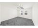 Bright bedroom with neutral carpet, ceiling fan, and two windows offering natural light. Spacious and ready for personal touches at 2692 Fairview Rd, Covington, GA 30016
