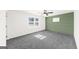 Comfortable bedroom with plush carpet, natural light, and a decorative accent wall at 2692 Fairview Rd, Covington, GA 30016