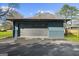 Detached one-car garage featuring neutral siding and brick accents. Functional space for vehicle storage or workshop at 2692 Fairview Rd, Covington, GA 30016