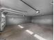 Spacious and clean garage with smooth concrete floor and newly installed door system. A blank slate ready for use at 2692 Fairview Rd, Covington, GA 30016