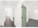 Hallway with hardwood floors, freshly painted walls, and interior doors leading to multiple rooms. Bright and clean transition space at 2692 Fairview Rd, Covington, GA 30016