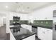 Modern kitchen featuring stainless steel appliances, white cabinets, and dark granite countertops at 2692 Fairview Rd, Covington, GA 30016