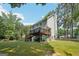 Lush backyard showcasing a spacious deck and mature trees, creating a serene and private outdoor space at 230 Wyngate Cir, Fayetteville, GA 30215