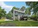 View of the home's backyard with a deck and partial garden, backing to a wooded lot at 230 Wyngate Cir, Fayetteville, GA 30215