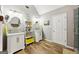 Bright bathroom featuring double vanity sinks and trendy wood look flooring at 230 Wyngate Cir, Fayetteville, GA 30215
