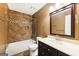 Full bathroom featuring a tile shower, vanity with a sink, and a large mirror at 230 Wyngate Cir, Fayetteville, GA 30215