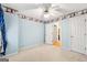 Neutral carpeted bedroom featuring ceiling fan and a light blue color scheme at 230 Wyngate Cir, Fayetteville, GA 30215