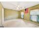 Carpeted bedroom with an American flag and plaid curtains hanging in the windows at 230 Wyngate Cir, Fayetteville, GA 30215