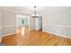 Dining room with decorative crown molding and bright hardwood flooring open to additional rooms at 230 Wyngate Cir, Fayetteville, GA 30215