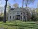 Charming two-story home with gray siding, black front door, and a large grassy yard at 230 Wyngate Cir, Fayetteville, GA 30215