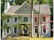 Charming two-story home with gray siding, black front door, and mature trees at 230 Wyngate Cir, Fayetteville, GA 30215