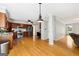 Open-concept kitchen featuring wooden floors and stainless steel appliances at 230 Wyngate Cir, Fayetteville, GA 30215