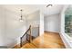 View of a well-lit staircase with wood steps, iron railings, and a large window at 230 Wyngate Cir, Fayetteville, GA 30215