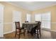 Breakfast nook features hardwood floors, a square table with four chairs, and natural light at 3973 Laurel Bend Dr, Snellville, GA 30039