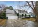 Traditional two-story home with a large two-car garage, a grey roof, and black shutters at 3973 Laurel Bend Dr, Snellville, GA 30039
