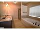 Luxurious bathroom featuring double vanity, a glass shower, and a soaking tub at 175 Osier Dr, Mcdonough, GA 30252