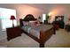 Elegant main bedroom featuring vaulted ceiling, seating and a luxurious dark wood bed at 175 Osier Dr, Mcdonough, GA 30252