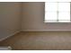 Bright bedroom featuring carpet floors, a large window, and neutral walls at 175 Osier Dr, Mcdonough, GA 30252