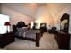 Large main bedroom with vaulted ceiling, and elegant dark wood furniture at 175 Osier Dr, Mcdonough, GA 30252