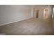 Spacious bonus room features carpeted floors, neutral walls, and two entry doors at 175 Osier Dr, Mcdonough, GA 30252