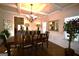 Elegant dining room with dark hardwood floors, wainscoting, coffered ceiling and natural light at 175 Osier Dr, Mcdonough, GA 30252