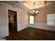 Elegant dining room featuring hardwood floors, coffered ceilings, and modern chandelier at 175 Osier Dr, Mcdonough, GA 30252