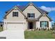 Charming two-story home with a two-car garage, white brick accents, and a well-manicured lawn at 175 Osier Dr, Mcdonough, GA 30252