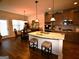 Modern kitchen features dark wood floors, granite island, dark cabinetry and stainless steel appliances at 175 Osier Dr, Mcdonough, GA 30252