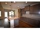 Modern kitchen with granite countertops, stainless steel sink, and dark wood cabinets at 175 Osier Dr, Mcdonough, GA 30252