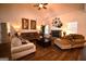 Comfortable living room with hardwood floors, plush seating, and a decorative fireplace with mantel decor at 175 Osier Dr, Mcdonough, GA 30252