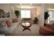 Cozy living room features neutral furniture, carpet, coffered ceiling and natural light at 175 Osier Dr, Mcdonough, GA 30252