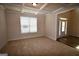 Bright living room with neutral carpet, trim accents, and a view of the front entrance at 175 Osier Dr, Mcdonough, GA 30252