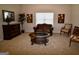Living room with traditional furniture, carpet, and bright natural light at 175 Osier Dr, Mcdonough, GA 30252