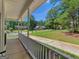 Relaxing front porch view with white railing, offering a glimpse of the landscaped front yard and neighborhood at 1302 Eddie Craig Ct, Mcdonough, GA 30252