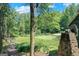 Expansive backyard showcasing a large grassy area and mature trees, perfect for outdoor activities at 5200A Burruss Mill Rd, Cumming, GA 30041