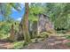 Exterior angle of a two-story home with stone foundation with lush surroundings at 5200A Burruss Mill Rd, Cumming, GA 30041