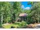 Charming two-story home with a red roof, surrounded by lush greenery, offering a serene and private setting at 5200A Burruss Mill Rd, Cumming, GA 30041