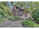 Charming two-story home featuring wood siding, a stone walkway, and beautiful landscaping at 5200A Burruss Mill Rd, Cumming, GA 30041